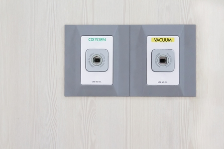 Medical Oxygen and Vacuum plug outlet pipelines on wood wall.の写真素材