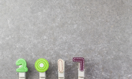 Happy new year 2017. Letters wood clothespin 2017 on a background of gray concrete. for any text into the blank area.の写真素材