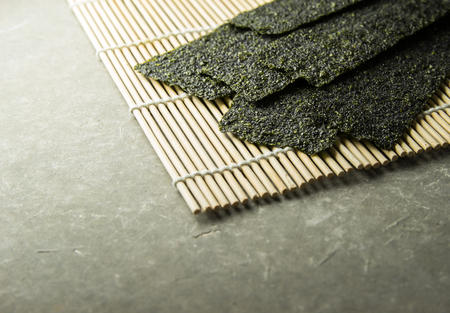 Seaweed roasted  snack (nori) on Japanese traditional bamboo mat.の写真素材