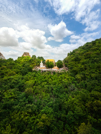 Buddha statue on mountain in Kanchanaburi, Thailand.の写真素材