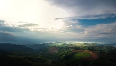 Landscape of the wind turbine on the mountains and sunlight.の写真素材