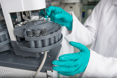 Centrifuge with tubes and hands in a laboratory