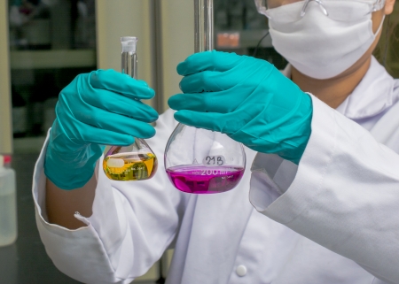 Hands holding test glasses with chemical insideの写真素材
