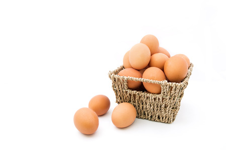 Fresh eggs in basket on white backgroundの写真素材