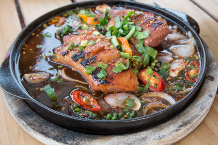 Thai Spicy grilled pork on hot plateの写真素材