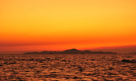 sunset sea mountain sky at Kolan Pattaya in Thailandの写真素材