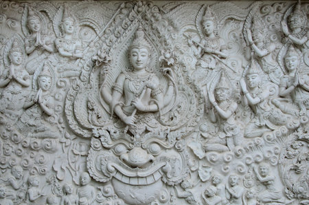 Sculpture on the wall in Thai temple.の写真素材