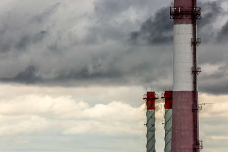 Air pollution in city environment, closeup of big industrial pipesの写真素材