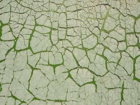 Green cement wall with cracked paint. Abstract grunge texture background. Copy space, empty template for textの写真素材