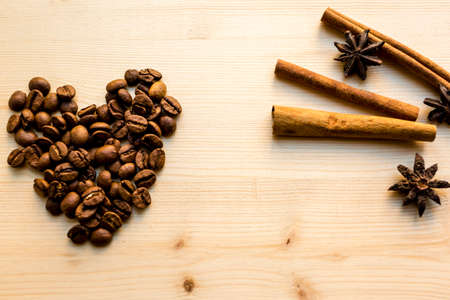 Cinnamon, Anise and coffee like a heart. The concept for a romantic morning, Valentine's Day, birthdays. Romantic artistic image.の写真素材