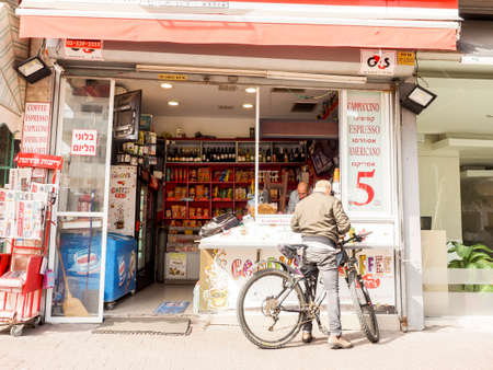 Tel Aviv, Israel - February 4, 2017: Man on the bike standing near coffee kiosk on Ben Yehuda street.のeditorial素材