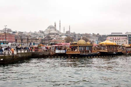 Istanbul, Turkey - December 6, 2014: The Suleymaniye Mosque view from Golden Horn, people visit the cafe in boats and watch Bosphorus in Istanbul.のeditorial素材