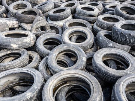 Large pile of tires dump. Illegal garbage dump. The concept of ecology pollution.