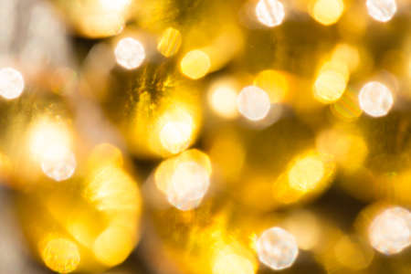 Defocused yellow golden lights. Festive bright backgroundの写真素材