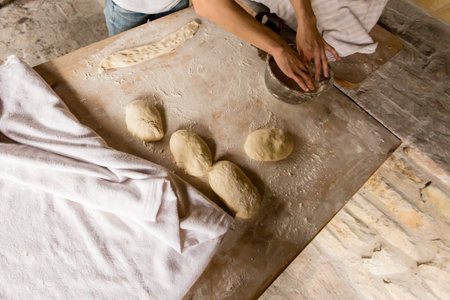 Close up image of cook hands kneading the dough for pies, culinary concept