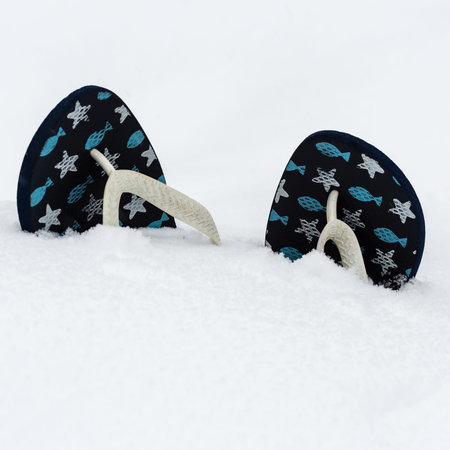 Flip flops in white fluffy snow. Dreams about summer holidays. Concept of summer sea recreation for...