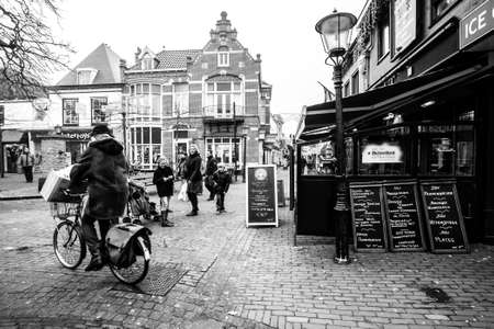 Den Hoorn, The Netherlands - February 25, 2010: People walking along the street in the small town Den Hoorn on Texel island.のeditorial素材