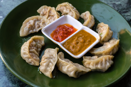 Traditional asian food. Nepalese steamed dumpling momo served with tomato chutney.