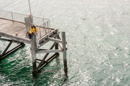 Kangaroo Island, Australia - January 2, 2009: Fisherman fishing on a jetty of a Kangaroo Islandのeditorial素材