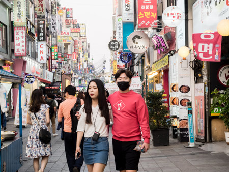 Suwon, South Korea - June 15, 2017: Young couple walking along the main street in Suwon.のeditorial素材