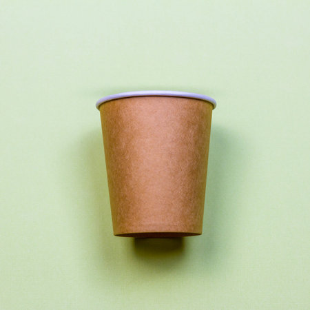 Paper cup made of eco kraft paper on the green background. Zero waste conceptの写真素材