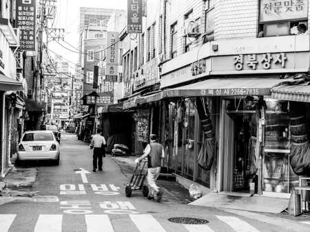 Seoul, South Korea - May 31, 2017: People walking down a small street near Cheonggyecheon stream in Seoul.