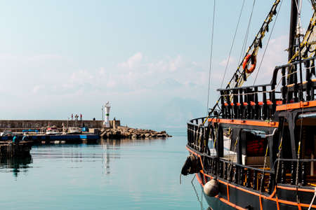 Antalya, Turkey - February 22, 2019: Old yacht at the pier near the lighthouse in the harbor in Old Town Kaleici in Antalya.のeditorial素材