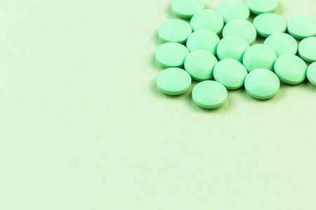 Green pills on the green background, medical bannerの写真素材