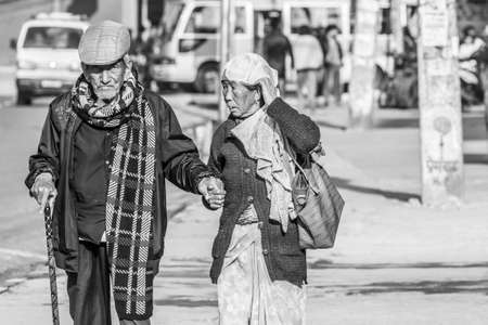Pokhara, Nepal - November 21, 2015: Elderly couple walking on the street in Pokhara, black and white imageのeditorial素材