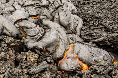 Eruption of volcano, boiling magma flowing through lava plains near the layer of solid lava, Kamchatka Peninsula, Volcano Tolbachik, Russiaの写真素材