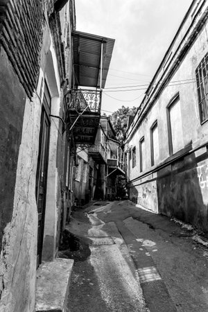 Narrow street in the old town of Tbilisi, Georgia. Low angle view, black and white imageの写真素材