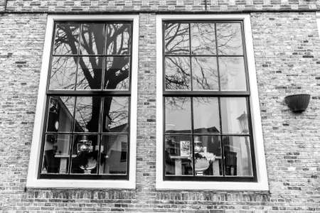 Amsterdam, The Netherlands - February 25, 2010: Reflections in old fashioned traditional window in Amsterdam.のeditorial素材
