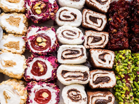Turkish delight with nuts, pistachios, coconut, chocolate and rose leaves. Rahat lokum, traditional Turkish sweets, Turkey.の写真素材