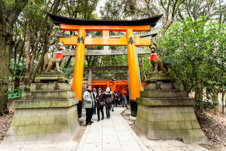 Kyoto, Japan - December 27, 2009: Tourists walking near Orange wooden torii tunnels in Fushimi Inari Taisha Shrine.のeditorial素材