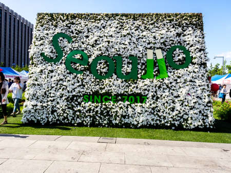 Seoul, South Korea - June 3, 2017: People walking in the Gwanghwamun Square near big flower bed with inscription: "Seoullo" Seoul, South Koreaのeditorial素材