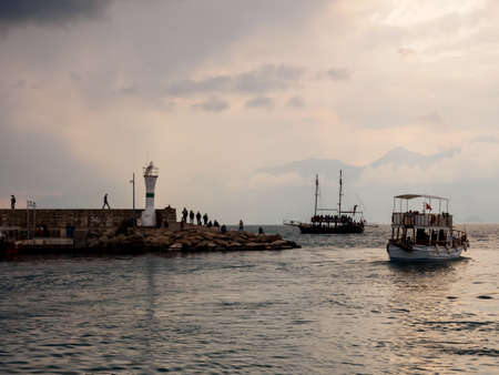 Antalya, Turkey - February 22, 2019: Yachts near the lighthouse in the harbor in Old Town Kaleici in Antalya.のeditorial素材