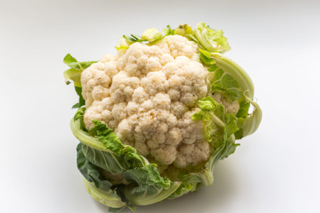 Fresh organic cauliflowers on the white background, healthy vegan food.