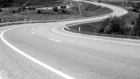Winding road going into the distance. Black and white image. Travel conceptの写真素材