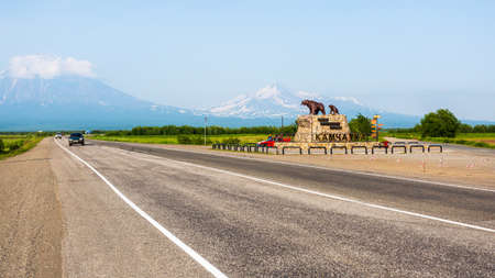 Yelizovo, Russia - July 17, 2018: Monument She bear with the cub on the background of volcano, near road. Caption: Here begins Russia.のeditorial素材