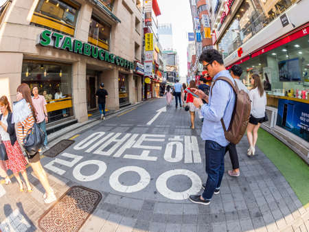 Seoul, South Korea - June 17, 2017: Man standing near Starbucks Coffee on the street in the city center.のeditorial素材