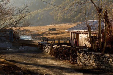 Braga, Nepal - November 11, 2015: Old woman standing on the street in the mountain village Braga (Braga) in Nepal, Himalayaのeditorial素材