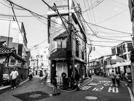 Seoul, South Korea - June 10, 2017: People walking down a small street near Changdeokgung Palace in Seoul, black and white imageのeditorial素材