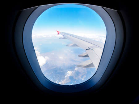 View of the mountains from the airplane porthole. Travel conceptの写真素材