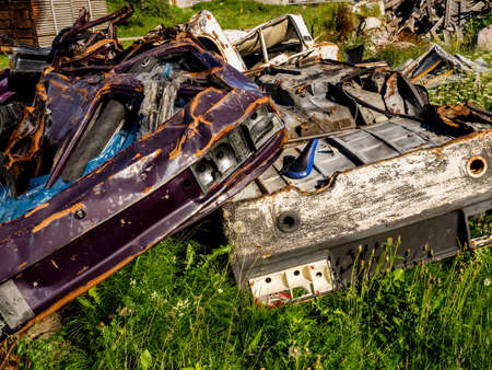 Illegal garbage dump. Large pile of metal, wooden and plastic waste. Pollution concept.の写真素材