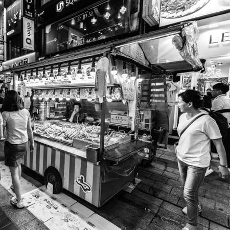 Suwon, South Korea - June 14, 2017: Vendor woman waiting of buyers in her fast food kiosk at main street in Suwon. Street food is very popular in Korea.のeditorial素材