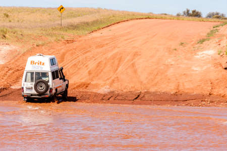 Alice Springs, Australia - December 30, 2008: Off-road car crossed the river on the country road, Australian Northern territoryのeditorial素材