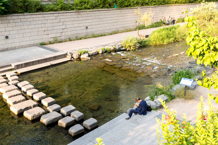 Seoul, South Korea - May 31, 2017: Man resting after work near Cheonggyecheon stream in Seoulのeditorial素材