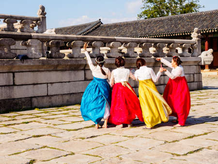 Seoul, South Korea - June 3, 2017 : Young women in colorful traditional wear - hanbok visiting the Gyeongbokgung Palace.のeditorial素材
