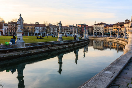 Florence, Italy - March 13, 2012: People resting on the lawn near the river in Florenceのeditorial素材