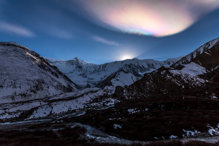 Rainbow cloud over the Himalayas. Sunset in the mountains, Nepal, Tilicho Base Camp, Annapurna region.の写真素材
